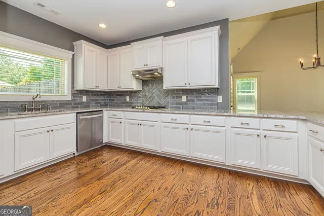 a kitchen with a sink window and cabinets