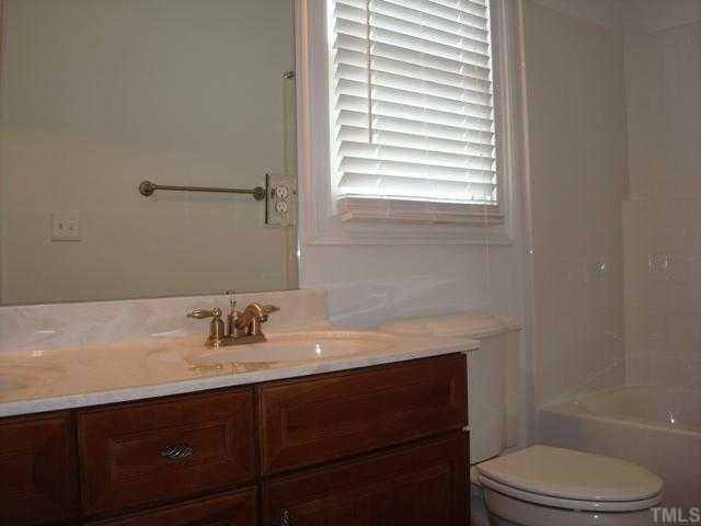 154 Fort Jackson Road Morrisville, NC 27560 - Photo 9 of 12 HALL FULL BATH UPSTAIRS IS TILED WITH UPGRADED VANITY AND BRIGHT WITH WINDOW