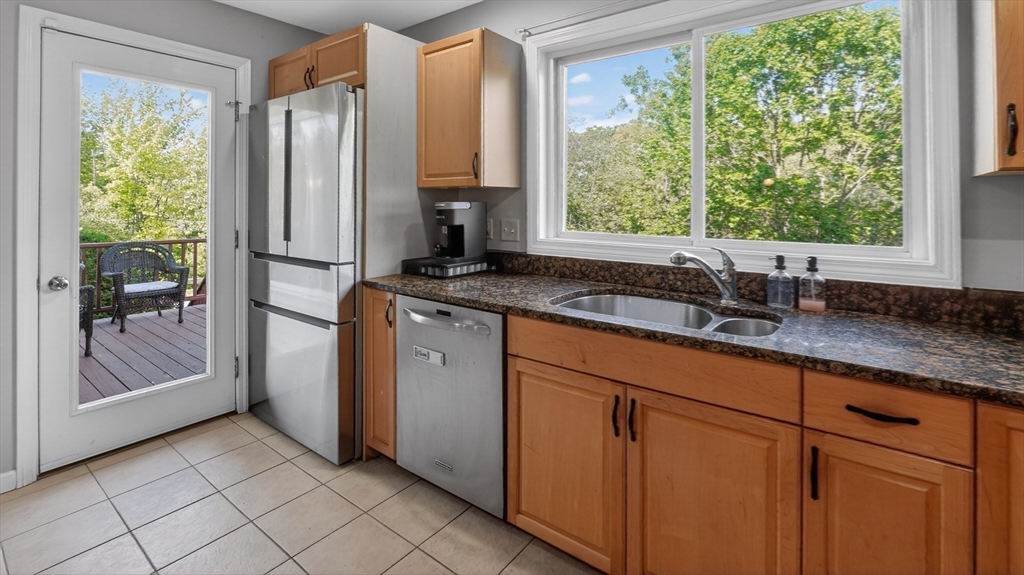 5 Governors Way, Unit B Milford, MA 01757 - Photo 17 of 42 a kitchen with stainless steel appliances granite countertop a refrigerator and a sink