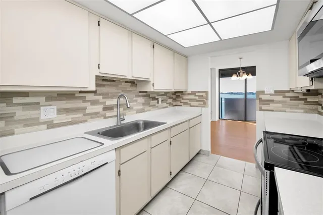 a kitchen with a sink cabinets and appliances