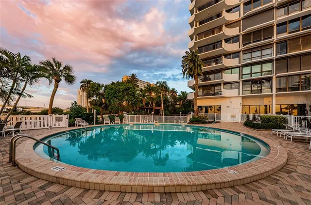a view of a chairs and table in the balcony