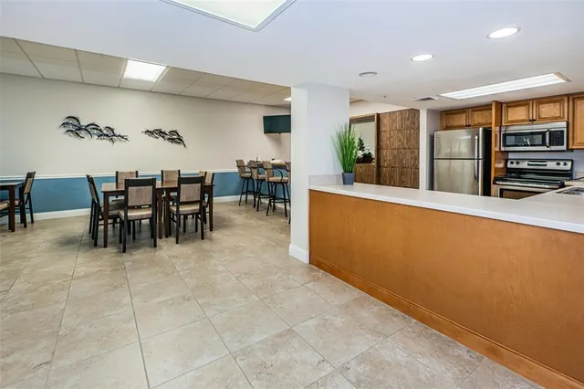 a living room with furniture large window and a table
