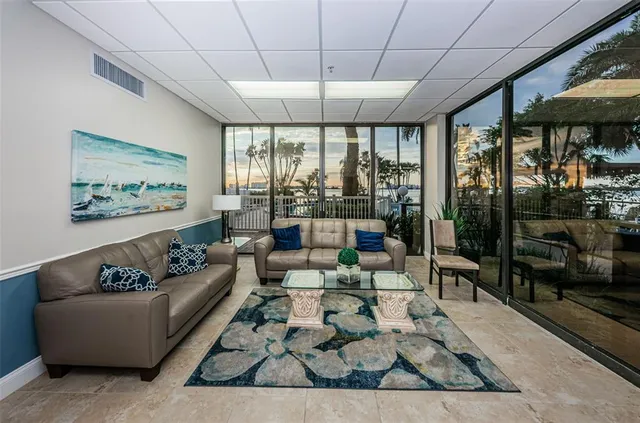 a living room with furniture and a dining table with projector the view