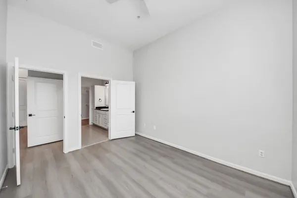 a view of empty room with wooden floor