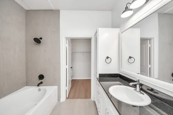 a bathroom with a sink a toilet and a mirror