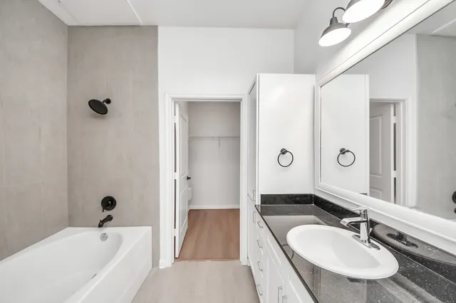 a bathroom with a sink a toilet and a mirror