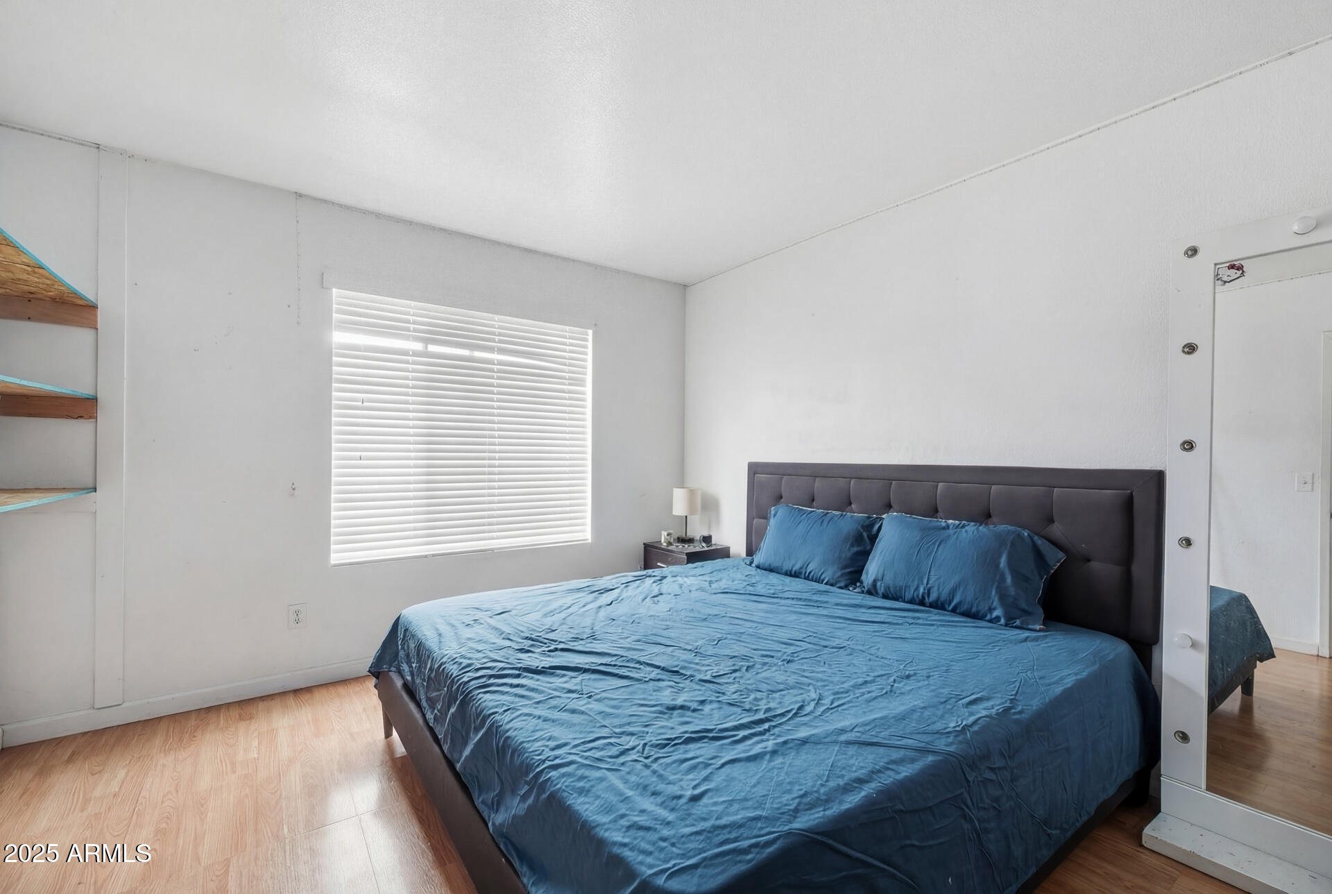 16065 West Jackson Street Goodyear, AZ 85338 - Photo 10 of 18 a bedroom with a bed and wooden floor