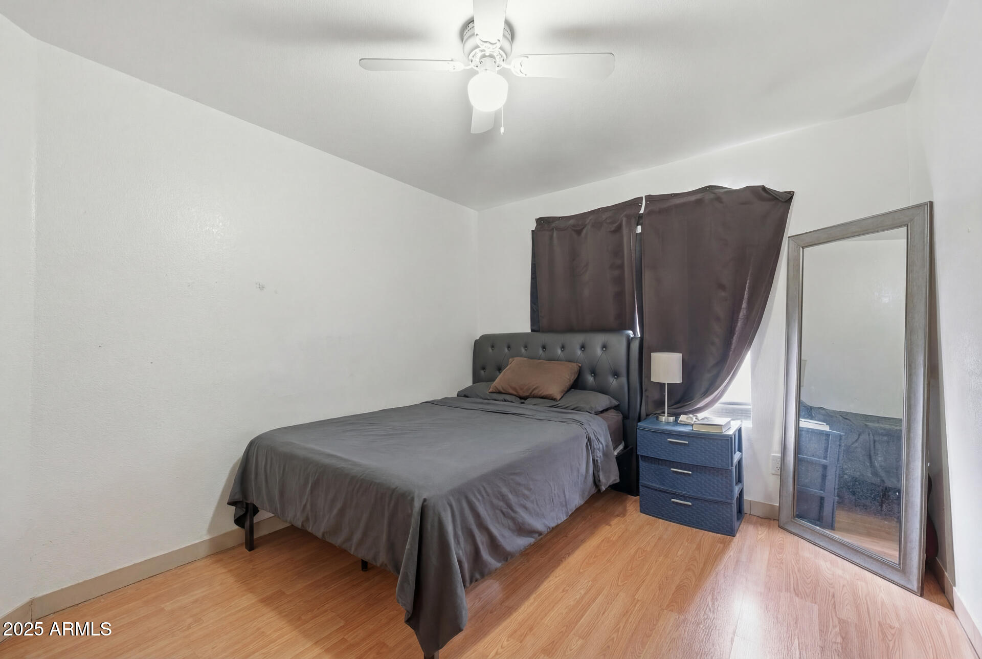 16065 West Jackson Street Goodyear, AZ 85338 - Photo 11 of 18 a bedroom with a bed and a mirror
