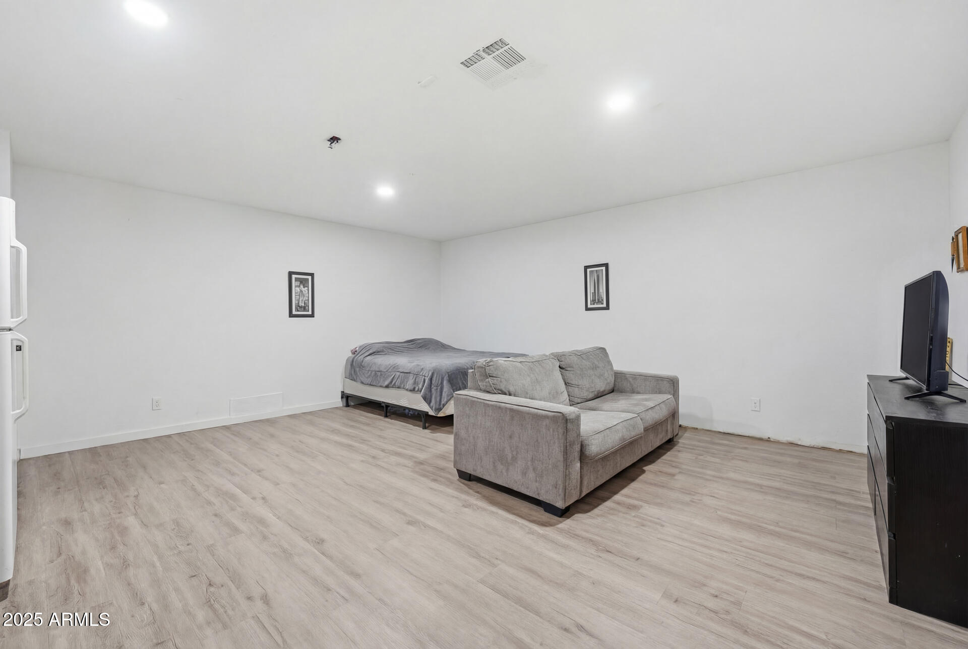 16065 West Jackson Street Goodyear, AZ 85338 - Photo 13 of 18 a living room with furniture and a flat screen tv