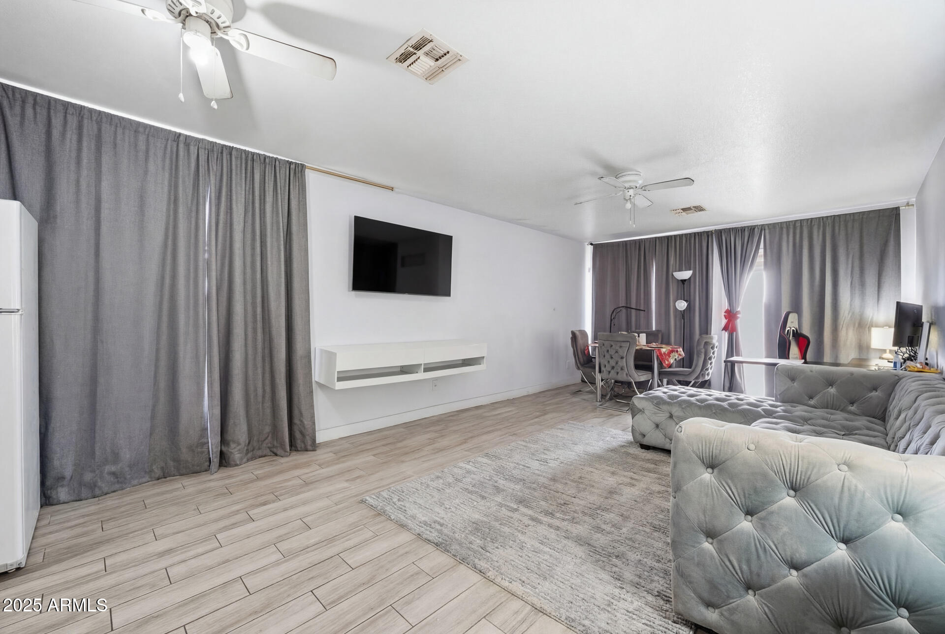 16065 West Jackson Street Goodyear, AZ 85338 - Photo 2 of 18 a living room with furniture and a flat screen tv
