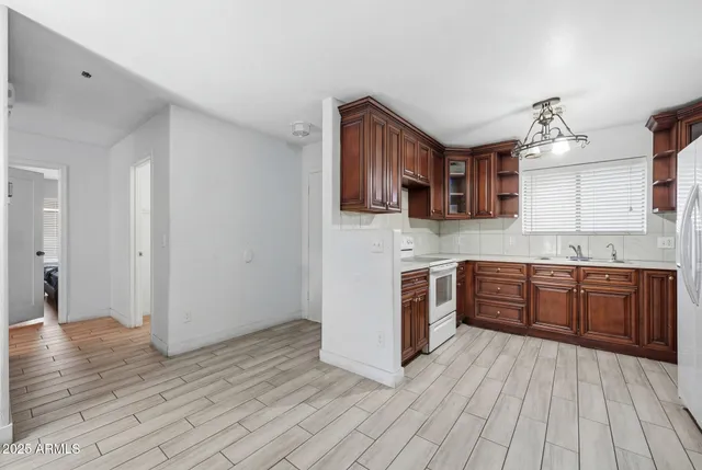 a kitchen with stainless steel appliances granite countertop a stove cabinets and wooden floor