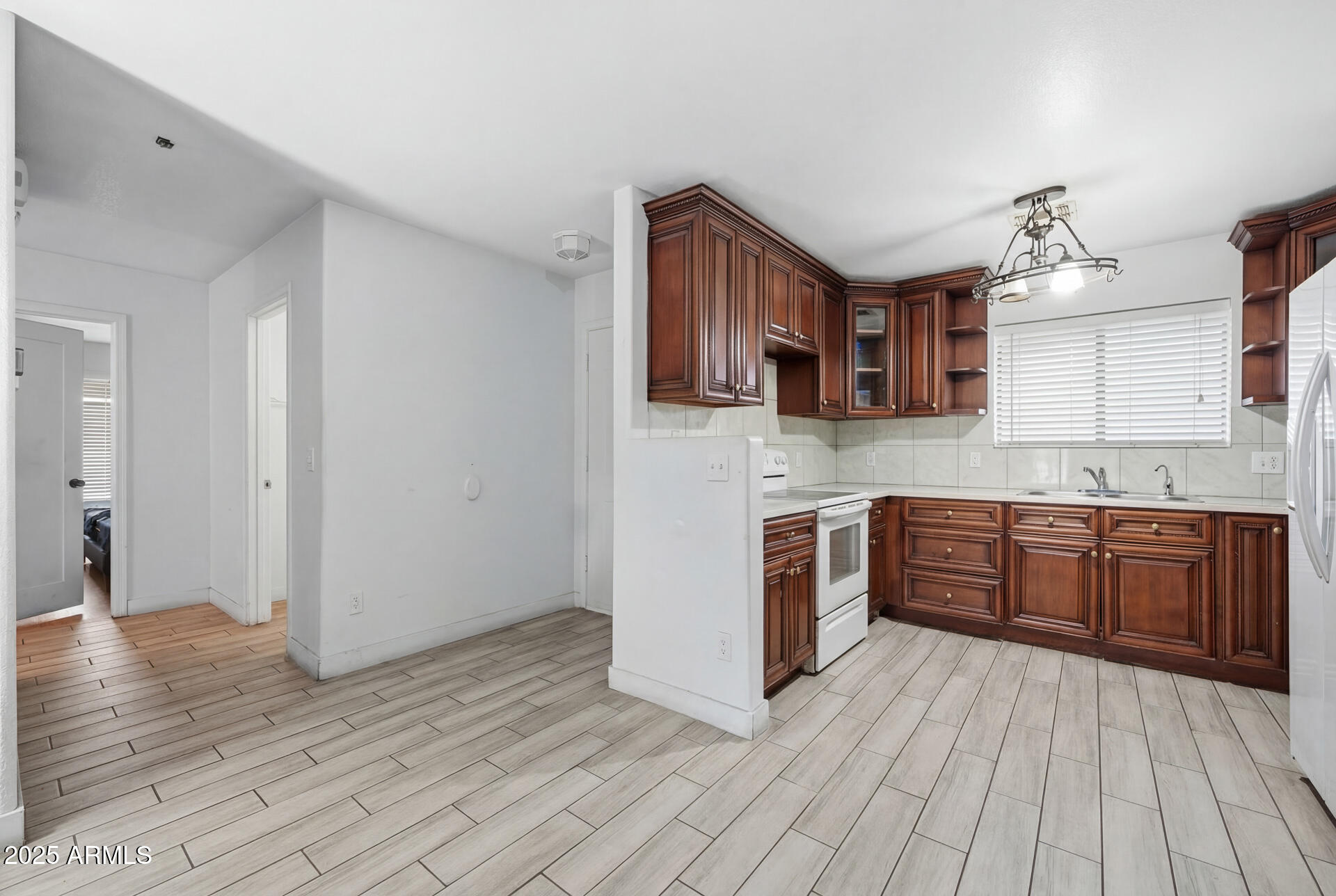16065 West Jackson Street Goodyear, AZ 85338 - Photo 4 of 18 a kitchen with stainless steel appliances granite countertop a stove cabinets and wooden floor