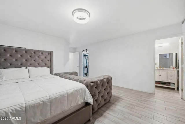 a bedroom with double bed and a table