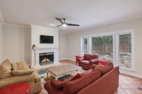 a living room with furniture a fireplace and a flat screen tv