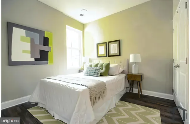 a bedroom with bed and a night stand