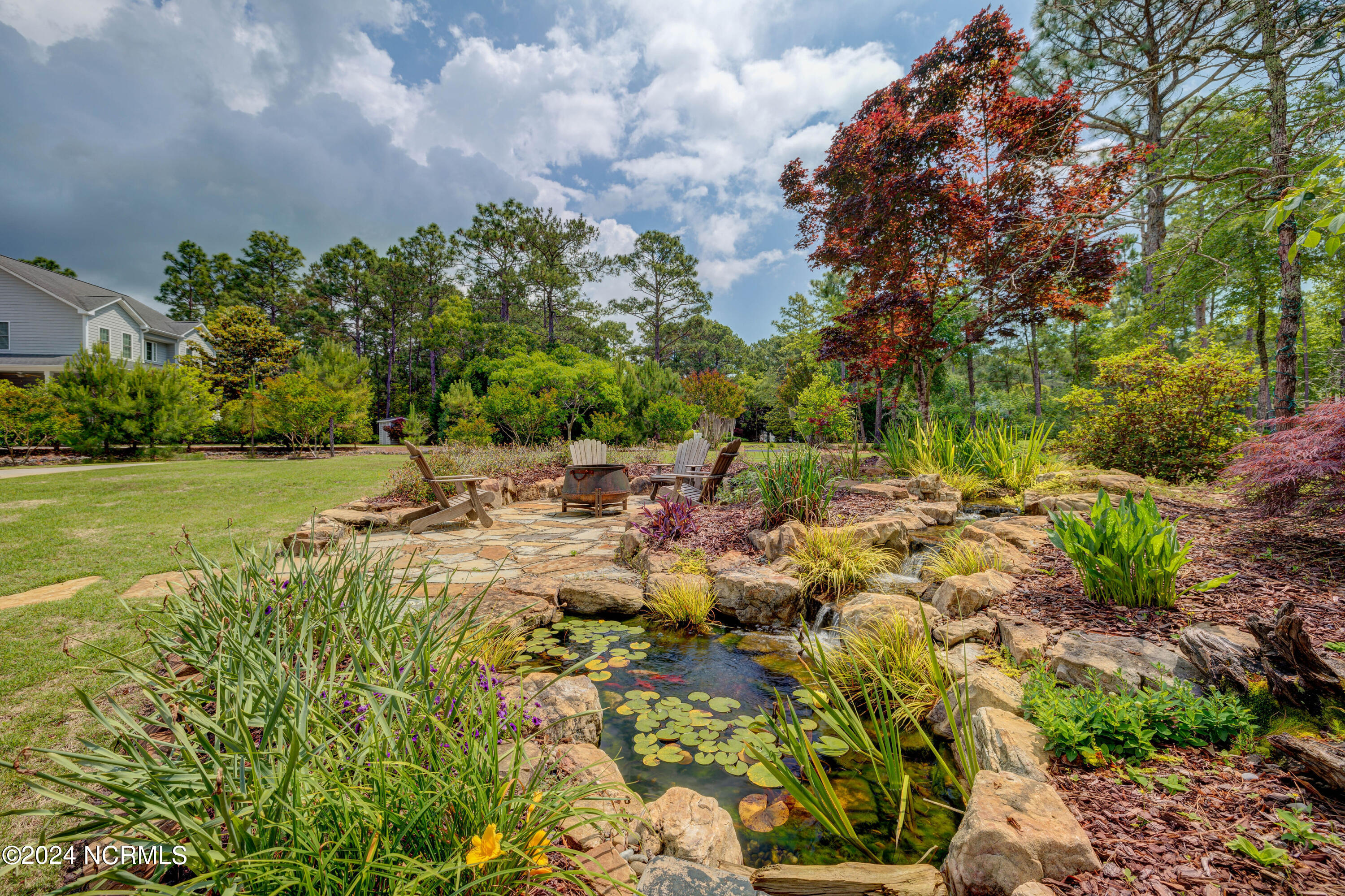 105 Duck Court Hampstead, NC 28443 - Photo 58 of 60 Stone Garden fire pit and koi pond
