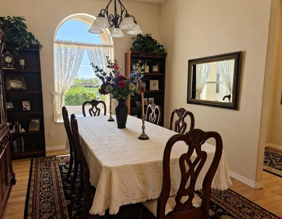 a view of a dining room with furniture and chandelier