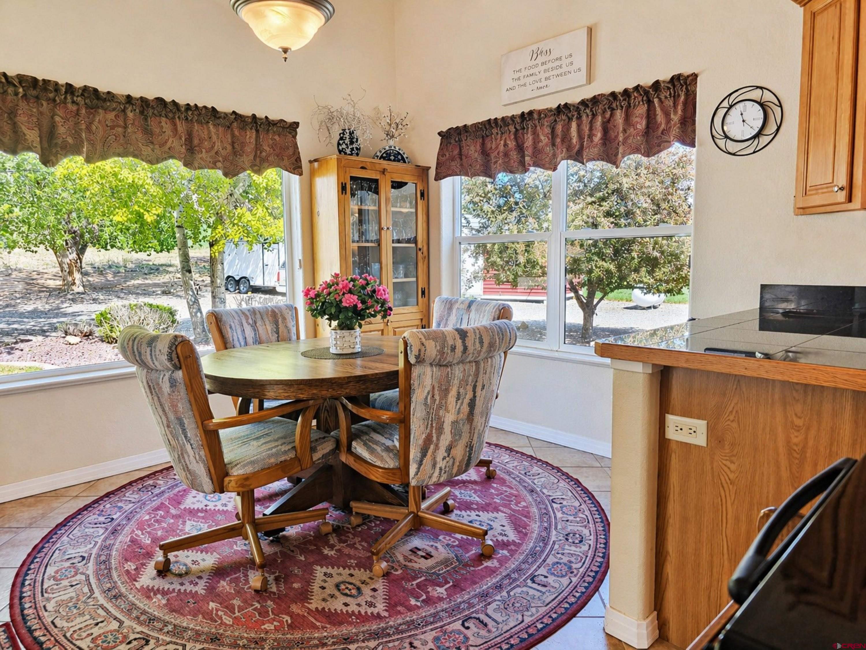 2357 5500th Road Delta, CO 81416 - Photo 12 of 37 a dining room with furniture a rug and a floor to ceiling window