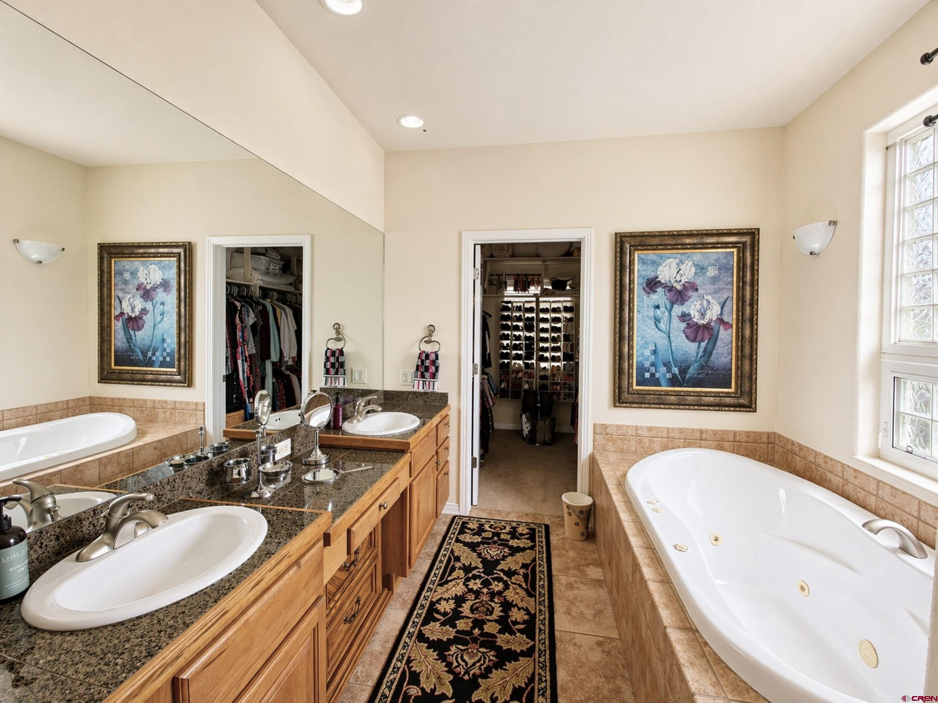 2357 5500th Road Delta, CO 81416 - Photo 15 of 37 a bathroom with a granite countertop tub sink and mirror