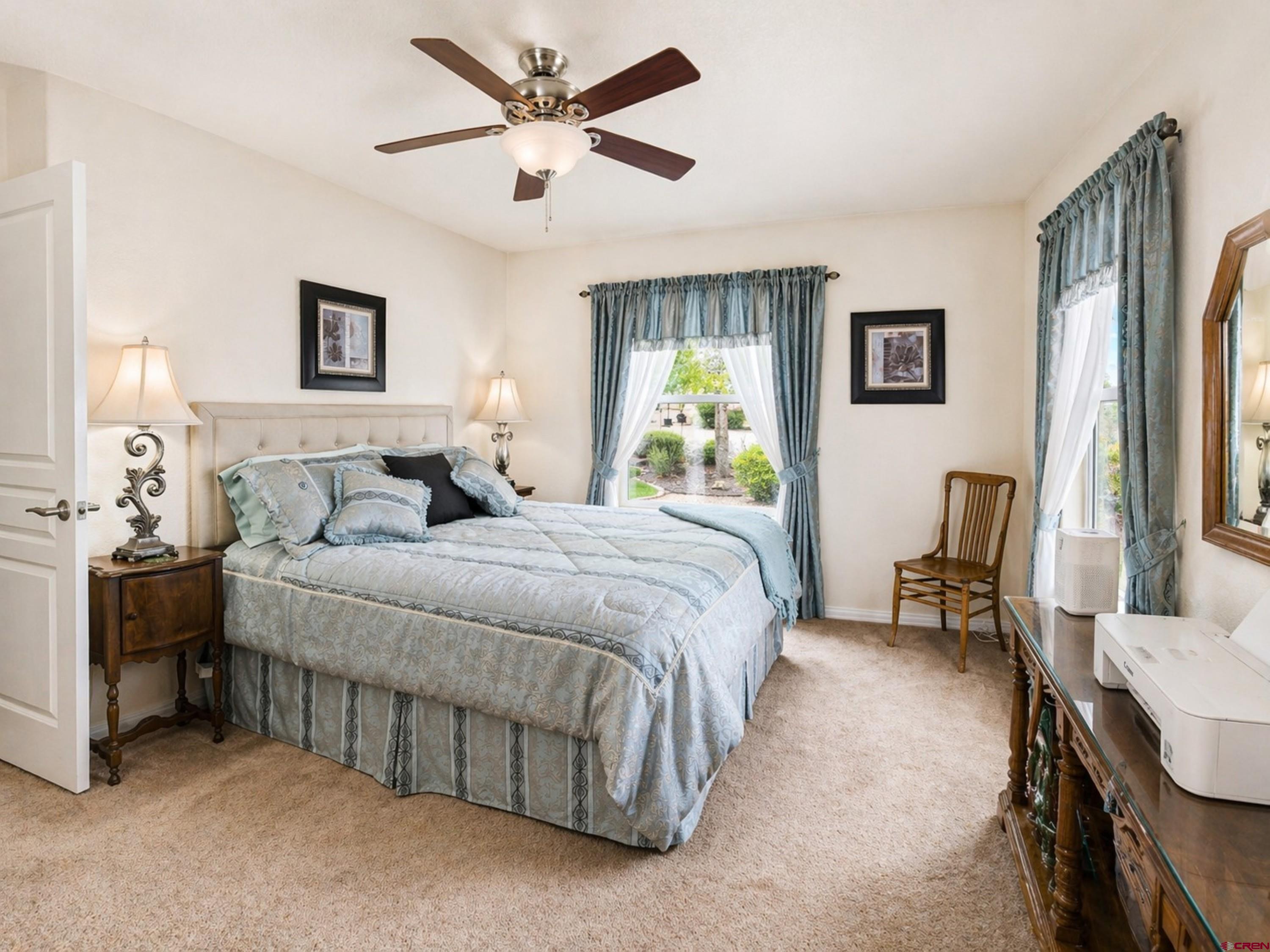 2357 5500th Road Delta, CO 81416 - Photo 20 of 37 a bedroom with a bed and a chandelier