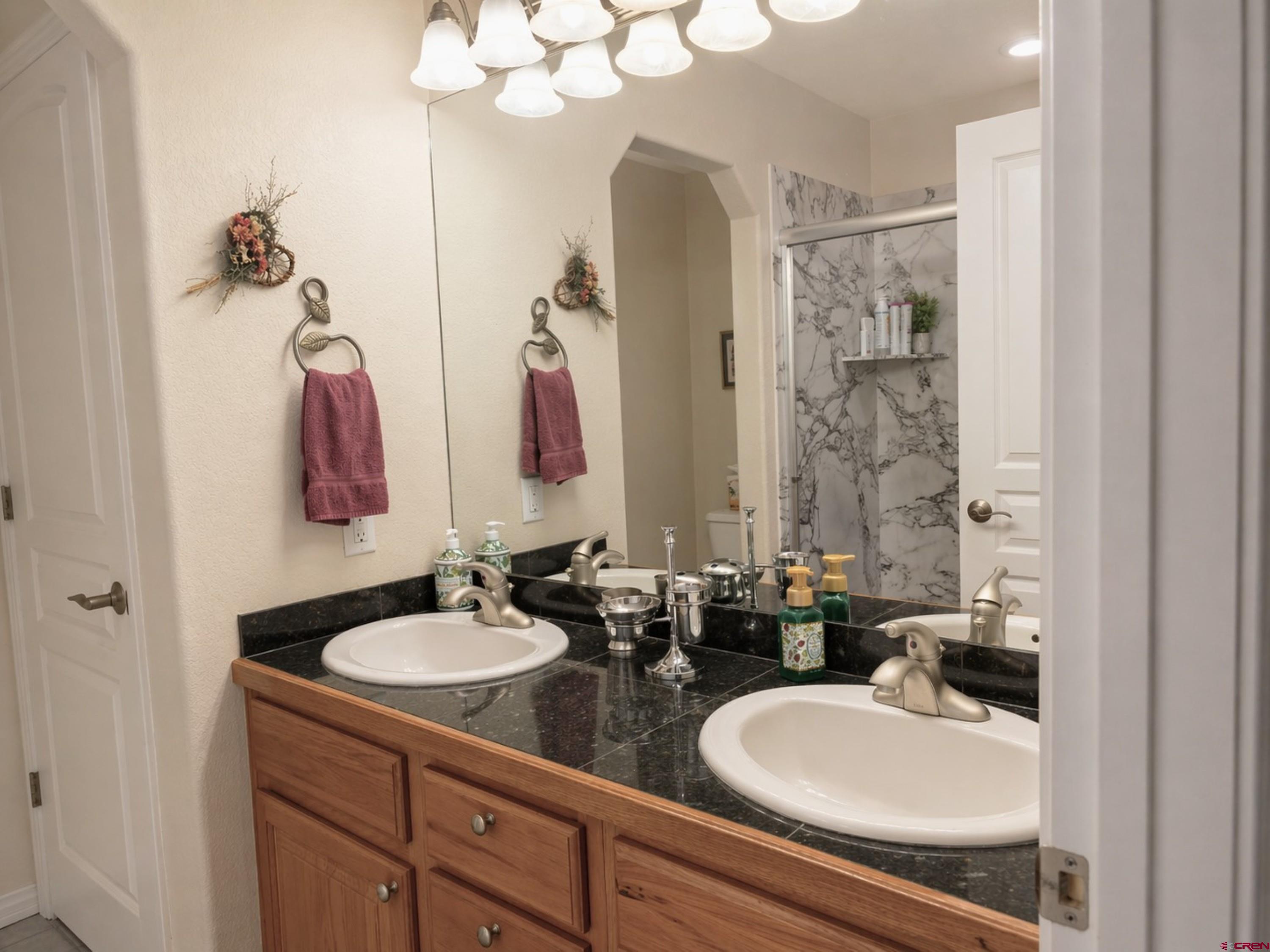 2357 5500th Road Delta, CO 81416 - Photo 23 of 37 a bathroom with double vanity sinks and a mirror