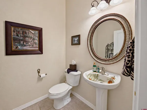 a bathroom with a toilet a sink and a mirror