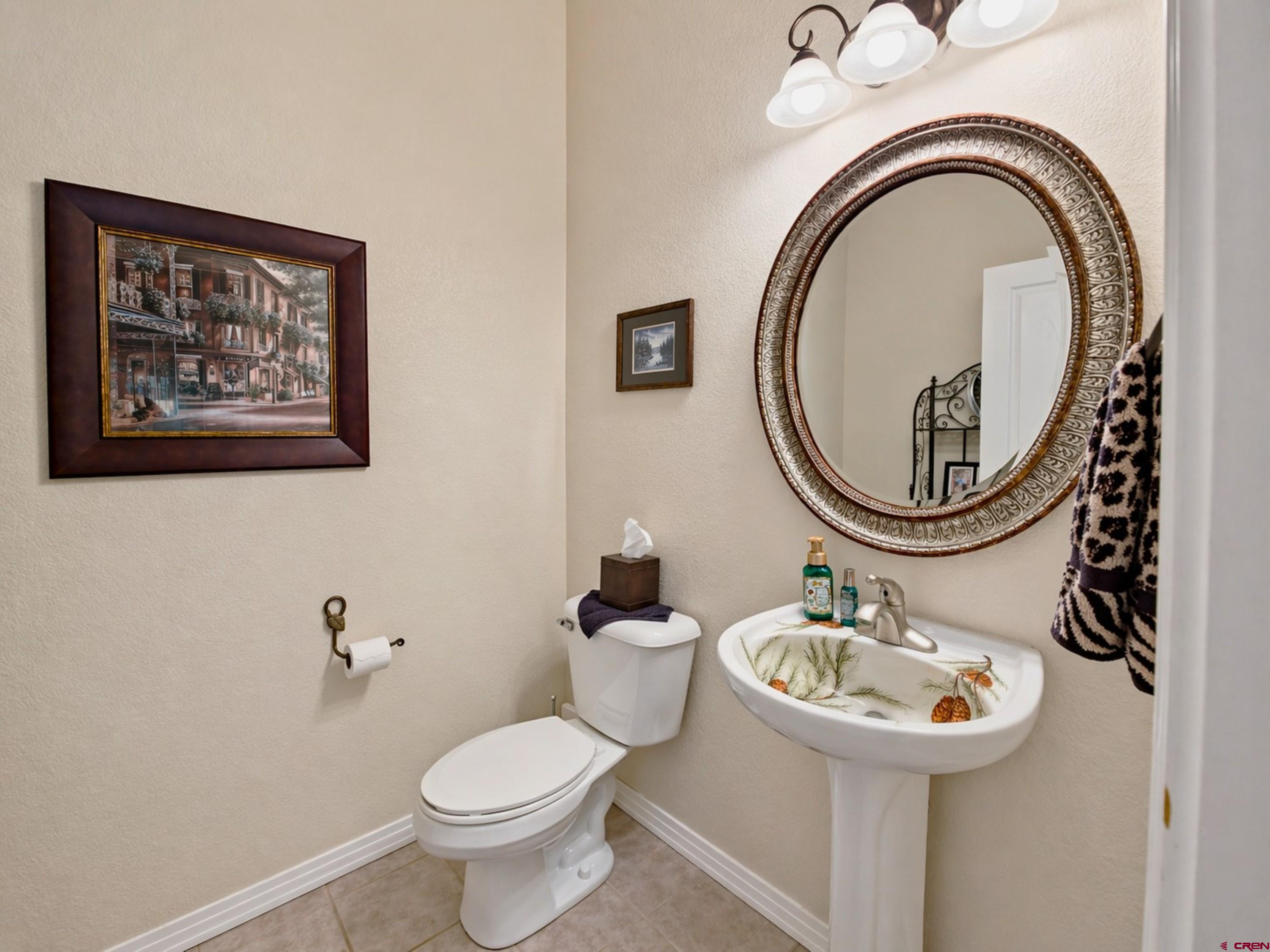 2357 5500th Road Delta, CO 81416 - Photo 24 of 37 a bathroom with a toilet a sink and a mirror