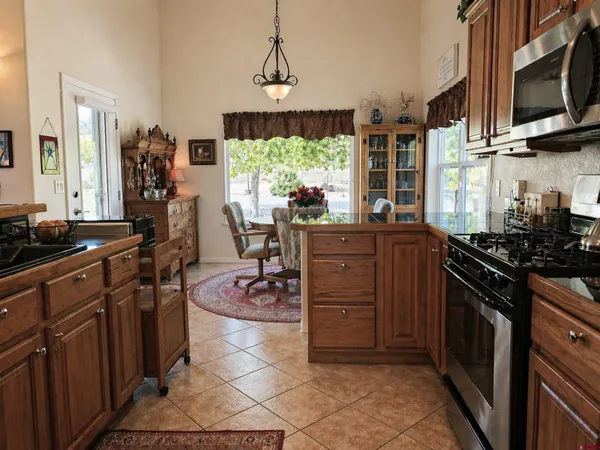 a kitchen with a sink stove and microwave