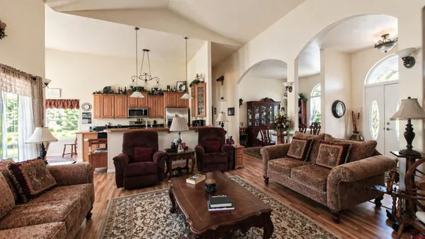 a living room with furniture wooden floor and a chandelier