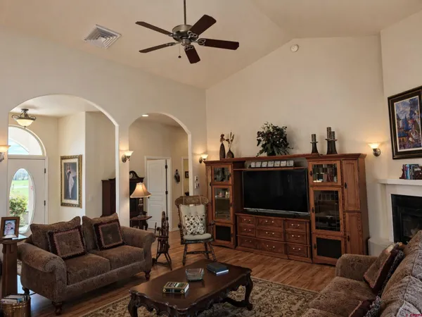 a living room with furniture a flat screen tv and a fireplace