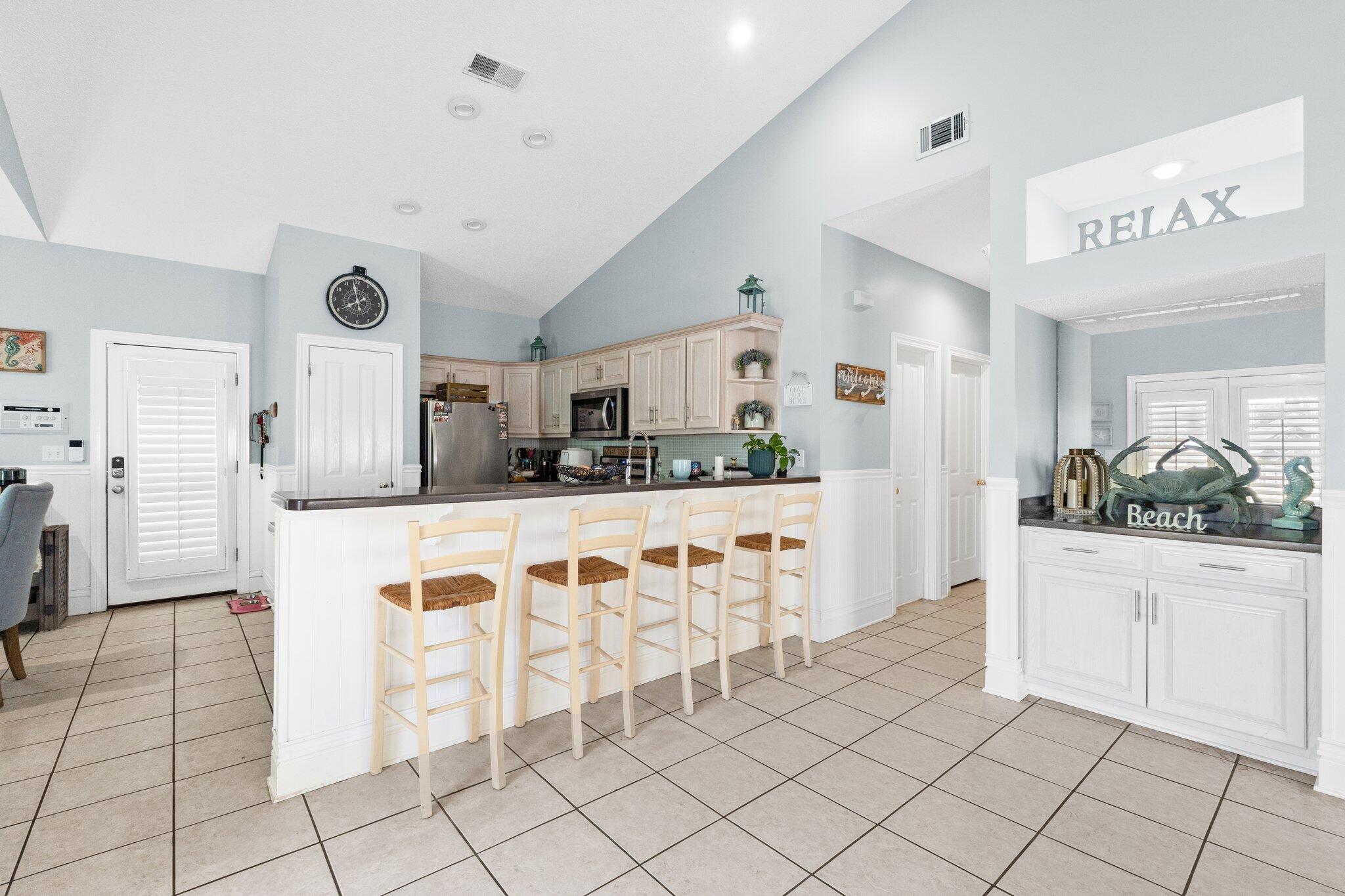 4460 Ocean View Drive Destin, FL 32541 - Photo 16 of 53 a kitchen with granite countertop white cabinets and refrigerator