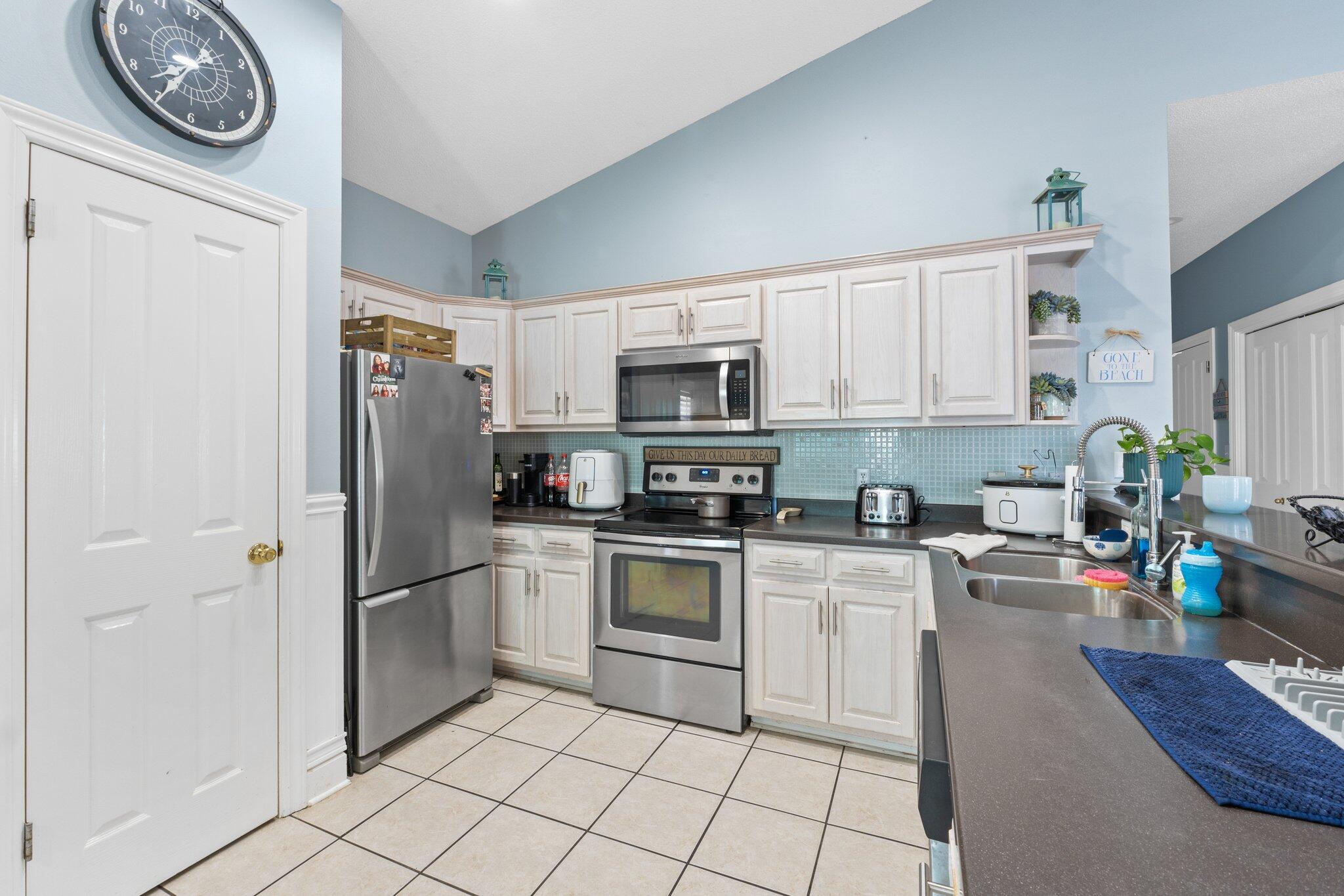 4460 Ocean View Drive Destin, FL 32541 - Photo 19 of 53 a kitchen with a refrigerator a stove a microwave and cabinets