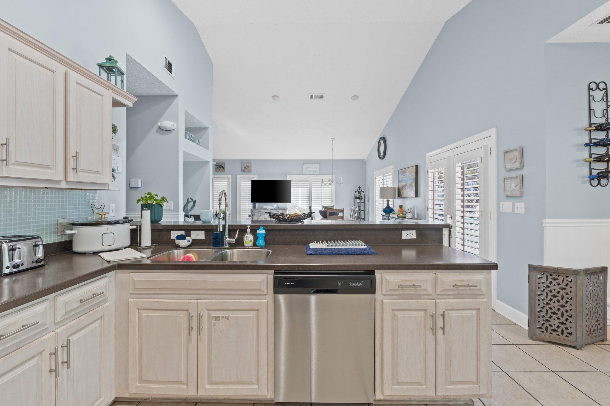4460 Ocean View Drive Destin, FL 32541 - Photo 20 of 53 a kitchen with white cabinets and sink