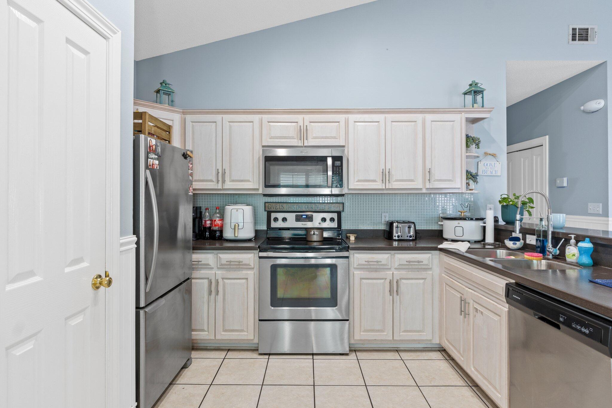 4460 Ocean View Drive Destin, FL 32541 - Photo 24 of 53 a kitchen with cabinets stainless steel appliances and a sink