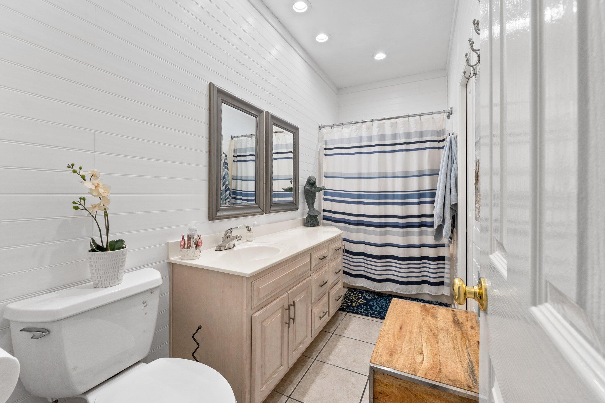 4460 Ocean View Drive Destin, FL 32541 - Photo 31 of 53 a bathroom with a sink a toilet and shower curtain