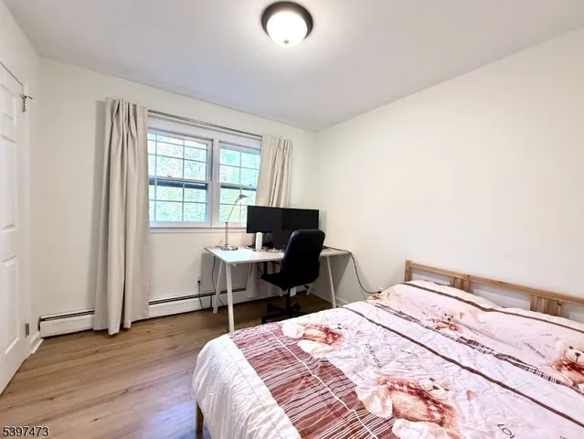 a bedroom with a bed and a desk