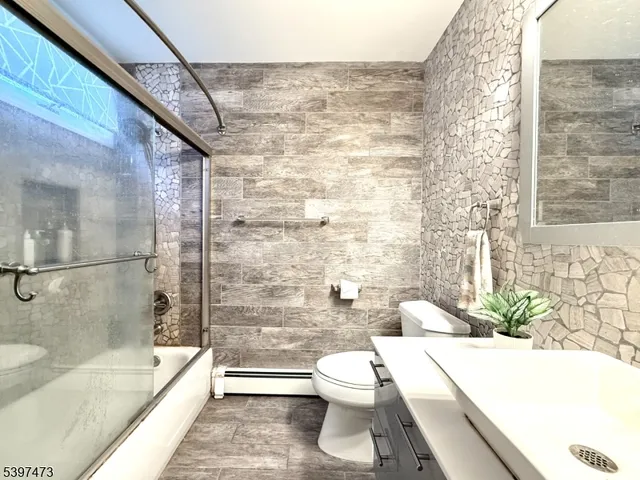 a bathroom with a toilet a sink and bathtub