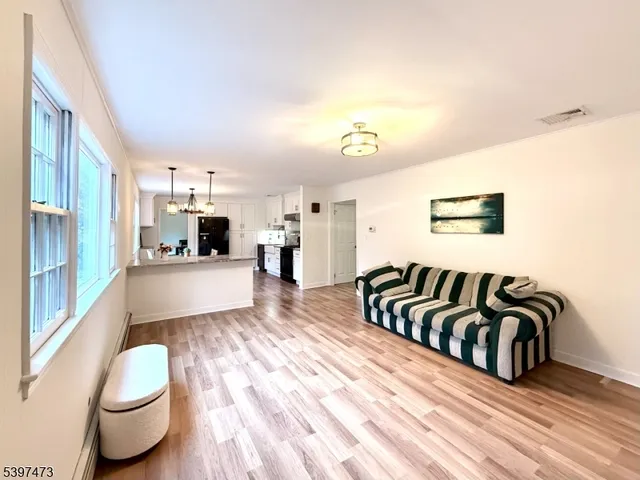 a view of a spacious bathroom with a window