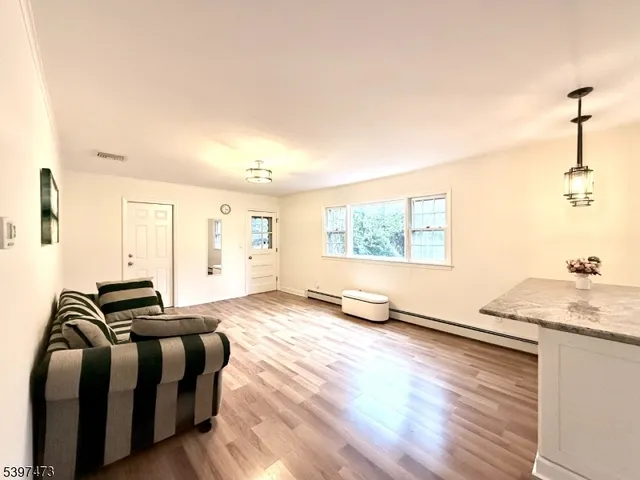 a living room with furniture window and wooden floor