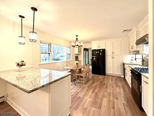a kitchen with a sink a counter top space and stainless steel appliances