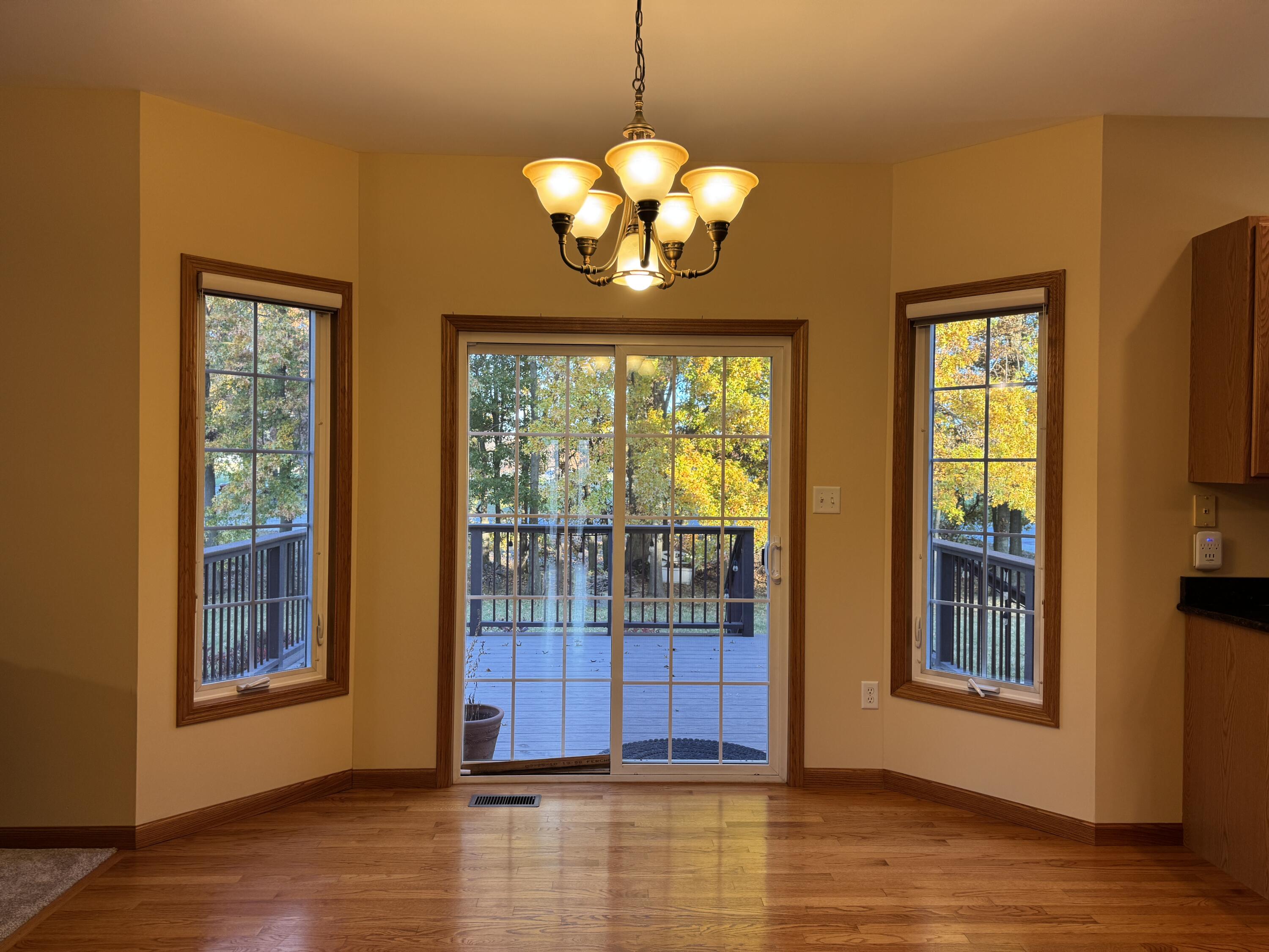 1521 Birdie Way Chesterton, IN 46304 - Photo 20 of 58 a view of a livingroom with wooden floor and a chandelier