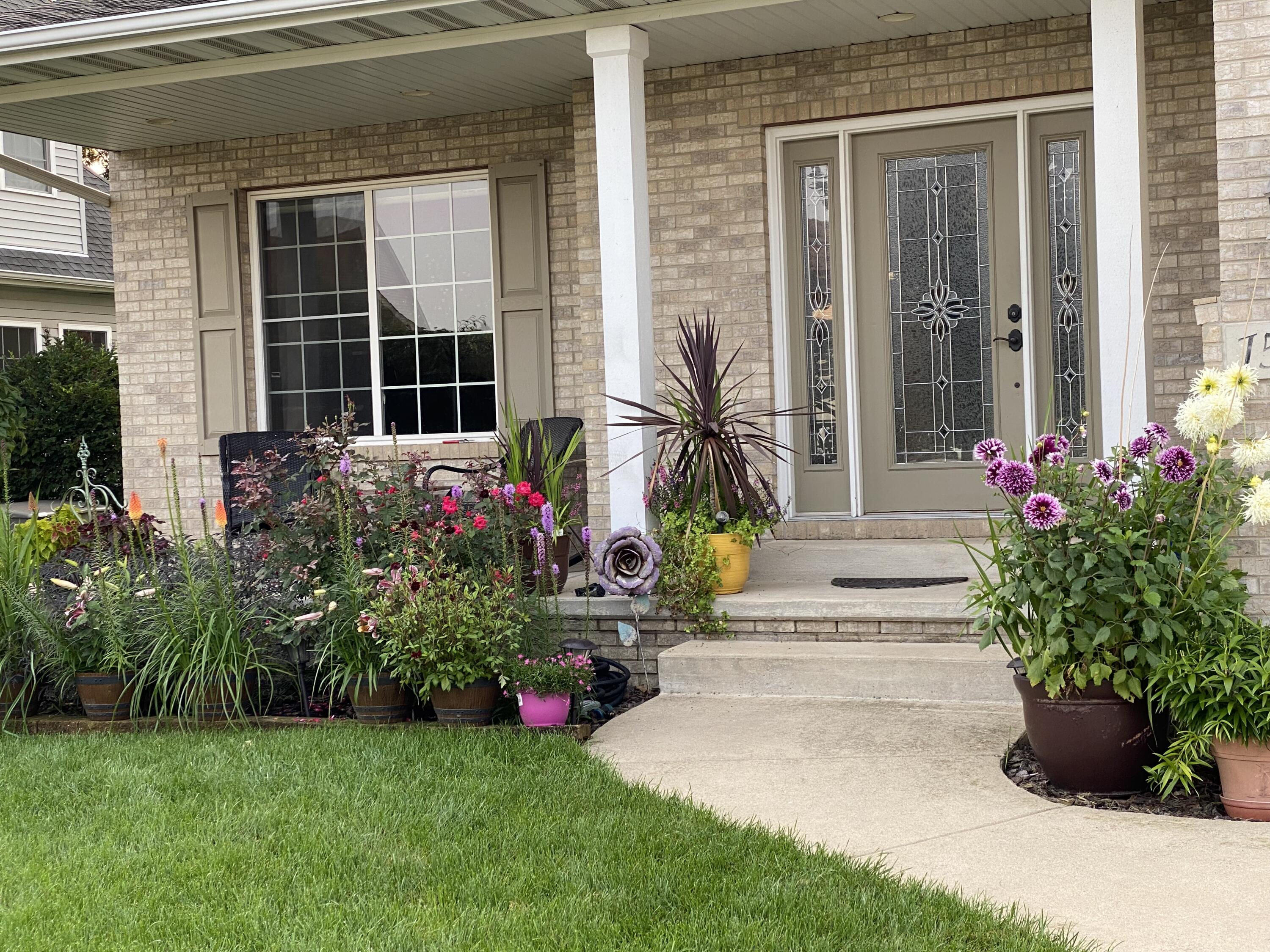 1521 Birdie Way Chesterton, IN 46304 - Photo 3 of 58 a view of a house with potted plants and a bench