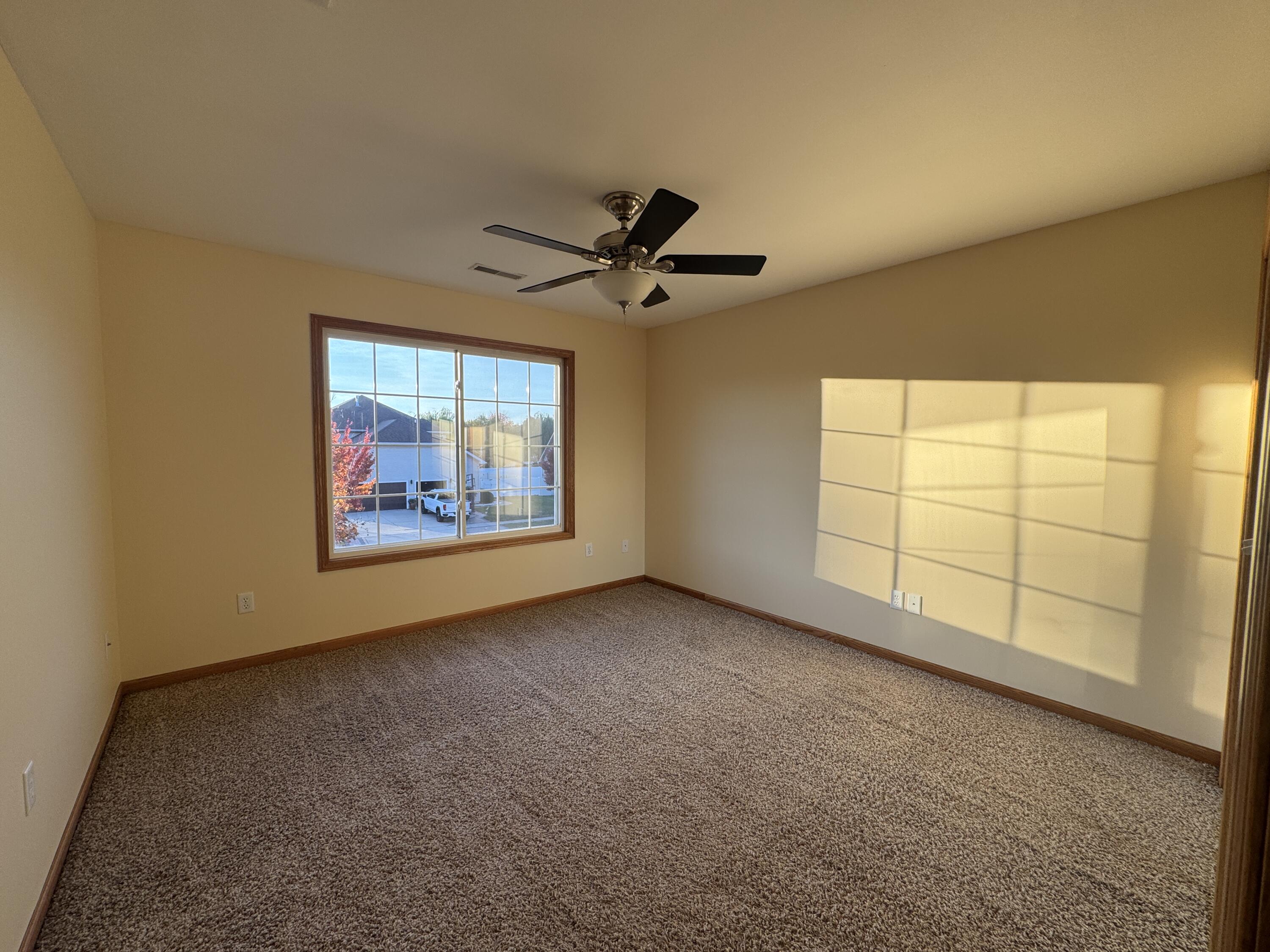 1521 Birdie Way Chesterton, IN 46304 - Photo 39 of 58 an empty room with windows and ceiling fan