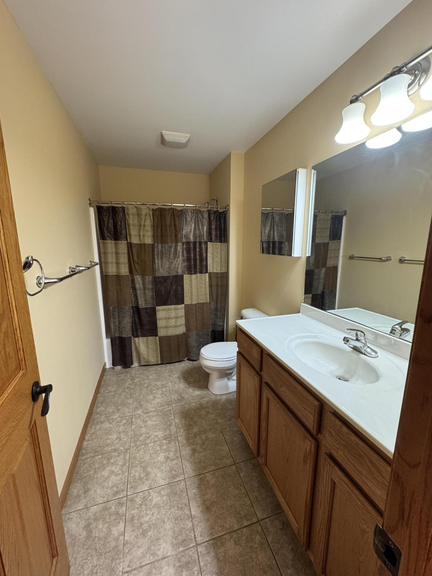 1521 Birdie Way Chesterton, IN 46304 - Photo 44 of 58 a bathroom with a sink a toilet a mirror and shower