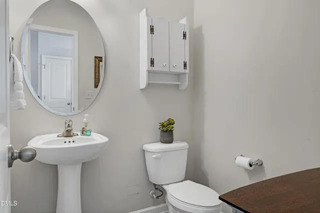 a bathroom with a sink toilet and mirror