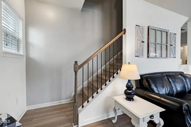 a living room with furniture and a dining table