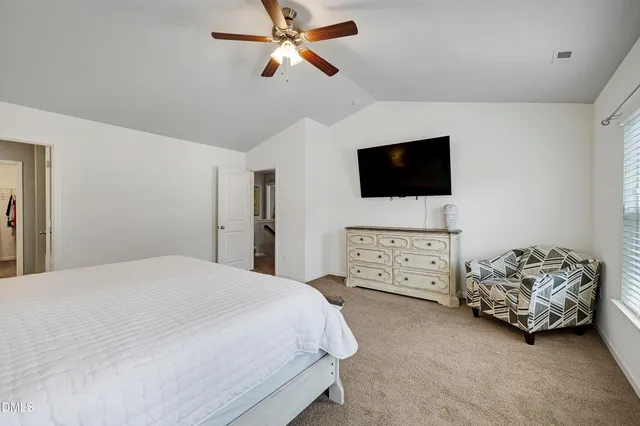 a bedroom with furniture and a flat screen tv