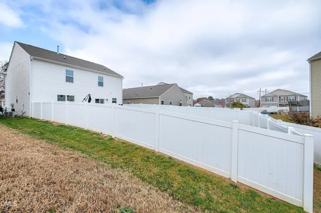 a view of a house with a yard and sitting area
