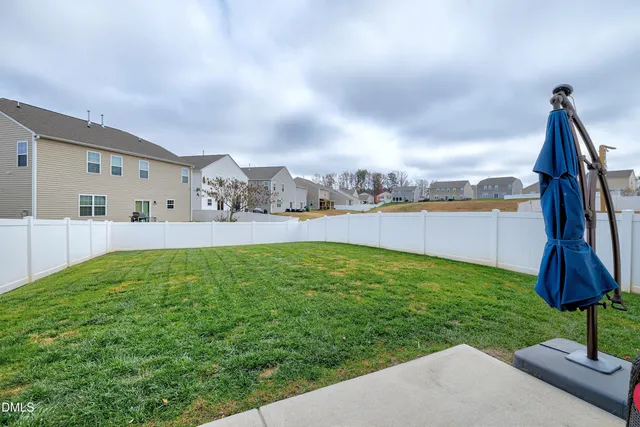 a swimming pool with outdoor seating and garden