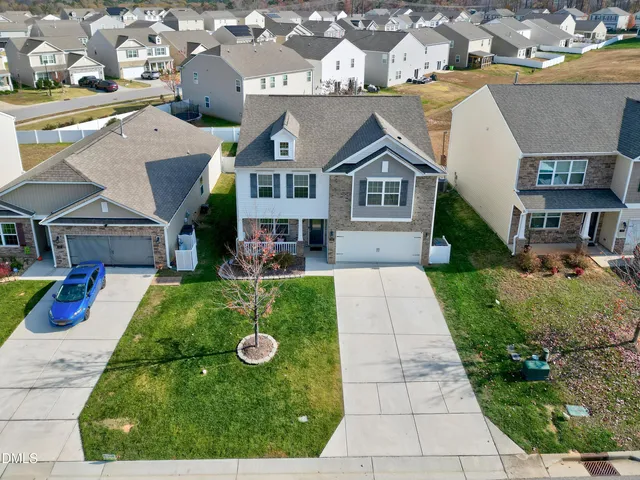 a aerial view of a house with a yard